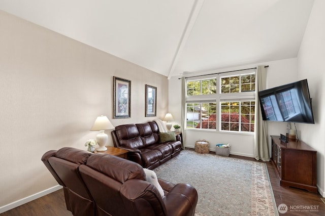 living area with baseboards, lofted ceiling with beams, and wood finished floors