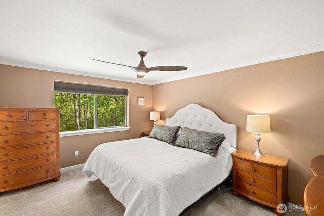 bedroom featuring carpet flooring, a ceiling fan, baseboards, and ornamental molding
