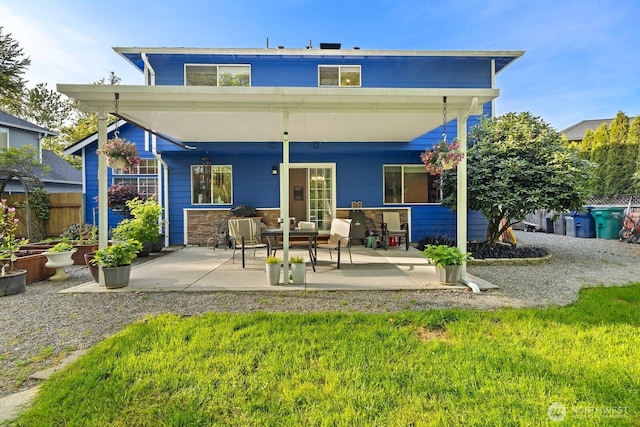 back of house featuring a patio area and fence