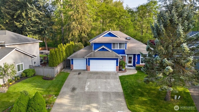 traditional-style home with fence, brick siding, a garage, a front yard, and driveway