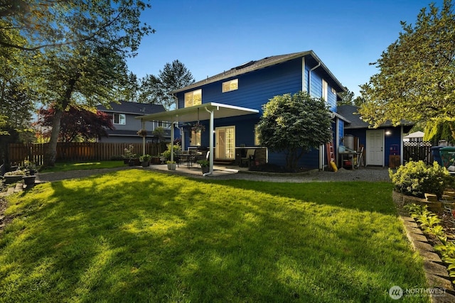 back of house featuring fence, a patio, and a yard