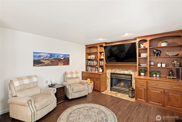 living room with dark wood-style flooring and a fireplace