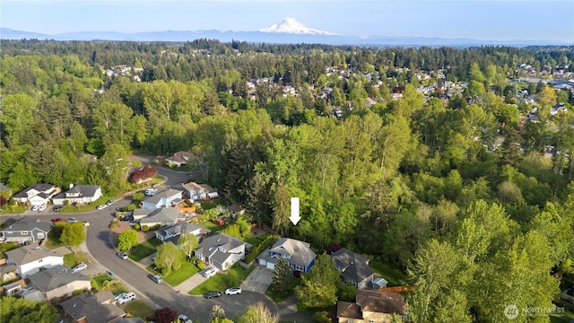 drone / aerial view featuring a view of trees and a residential view