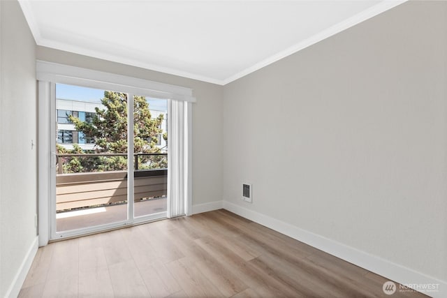 unfurnished room featuring crown molding, baseboards, light wood-style flooring, and visible vents