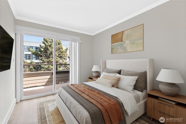 bedroom with crown molding, baseboards, and wood finished floors