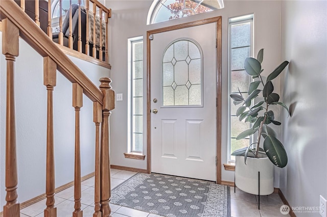 foyer entrance with tile patterned floors and plenty of natural light