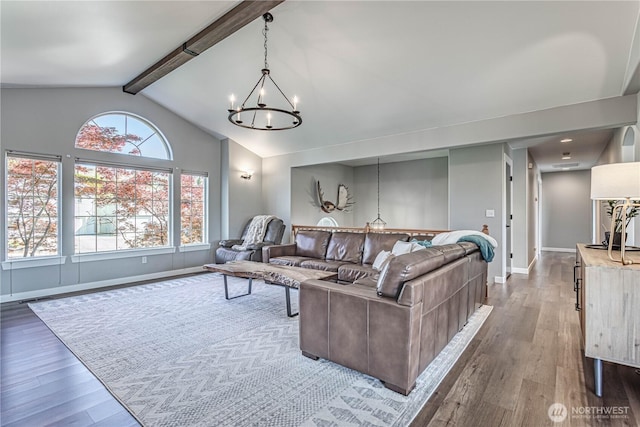 living area with baseboards, dark wood-style flooring, lofted ceiling with beams, and an inviting chandelier