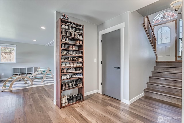 interior space featuring recessed lighting, baseboards, and wood finished floors