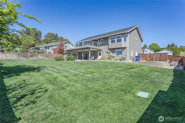 rear view of property with a yard and a fenced backyard