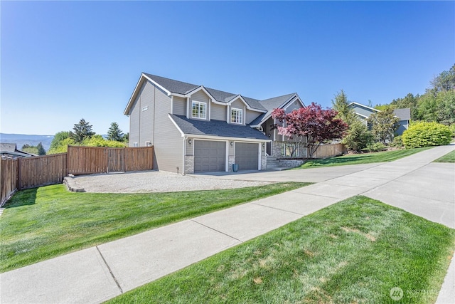 view of front of property with fence, a garage, a front lawn, and driveway