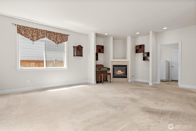 unfurnished living room with recessed lighting, baseboards, carpet, and a tile fireplace