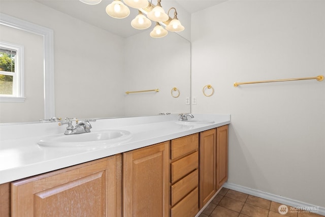 bathroom with a sink, tile patterned flooring, double vanity, and a chandelier