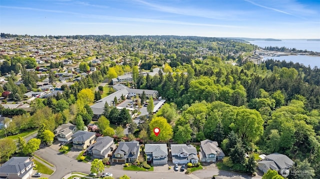 birds eye view of property with a water view and a residential view