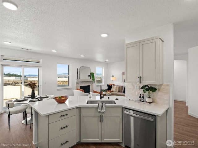 1349 Bill Ave, Walla Walla, WA 99362 - kitchen featuring dishwasher, a sink, a peninsula, open floor plan, and light countertops