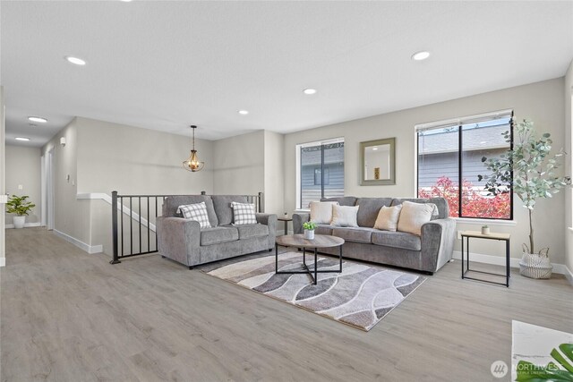 living room with baseboards, recessed lighting, and wood finished floors