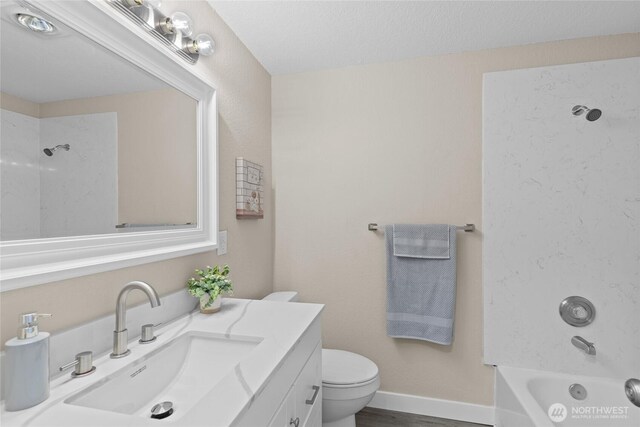 bathroom featuring vanity,  shower combination, and toilet