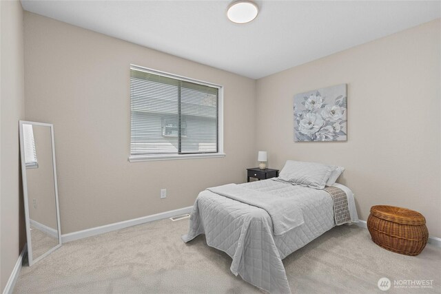 bedroom with baseboards and carpet flooring