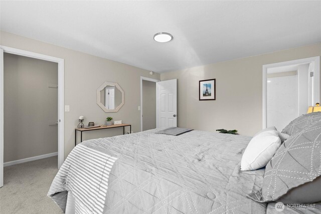 carpeted bedroom featuring baseboards