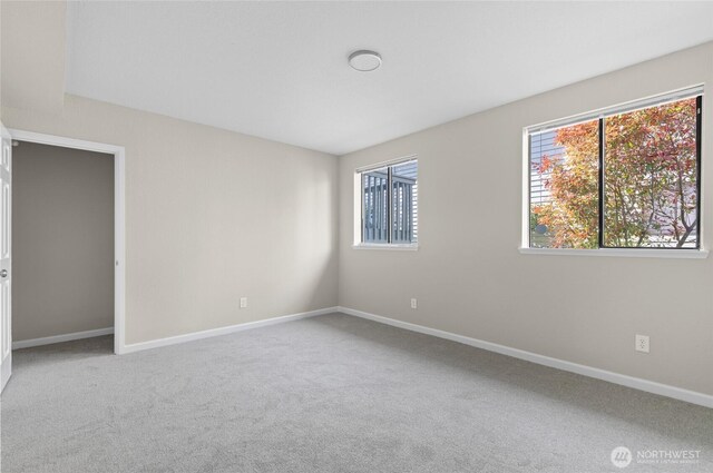 carpeted spare room with baseboards