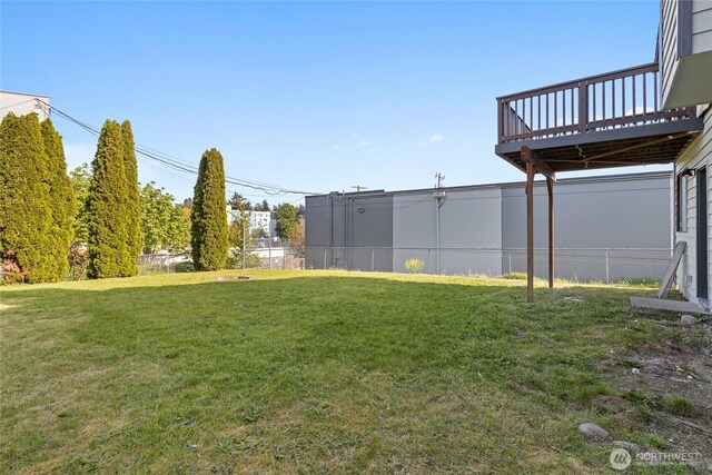 view of yard with fence and a deck