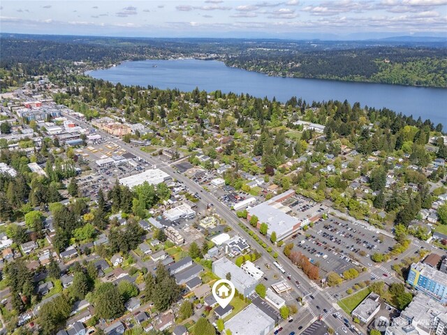 bird's eye view featuring a view of trees and a water view