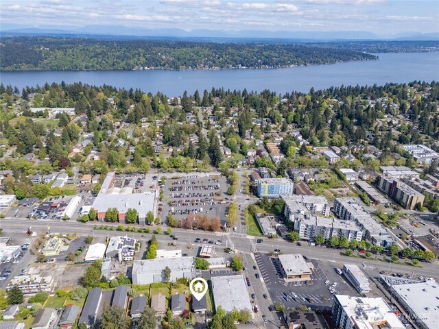 drone / aerial view featuring a water view and a forest view