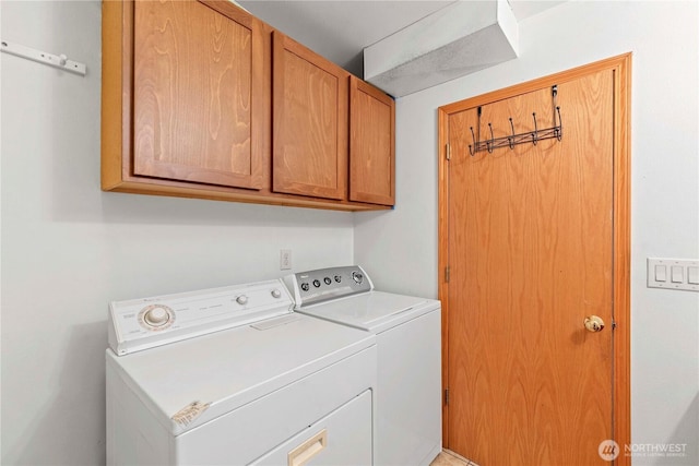 washroom with cabinet space and washing machine and dryer