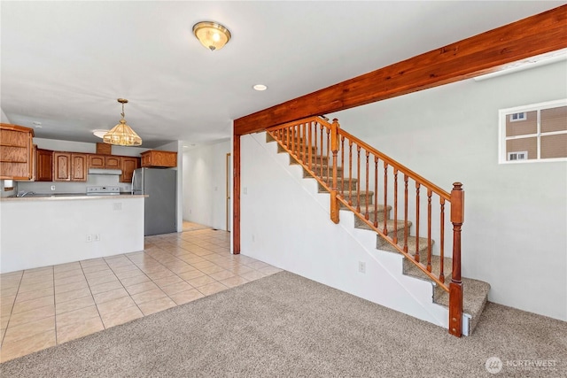 unfurnished living room featuring light tile patterned floors, recessed lighting, stairs, and light colored carpet