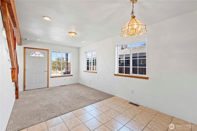 foyer with visible vents, light colored carpet, a notable chandelier, recessed lighting, and light tile patterned flooring