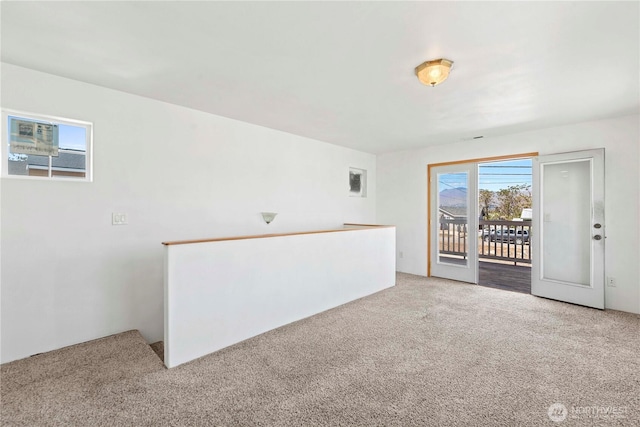 unfurnished room featuring light carpet
