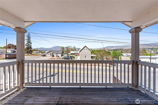 deck with a residential view and a mountain view