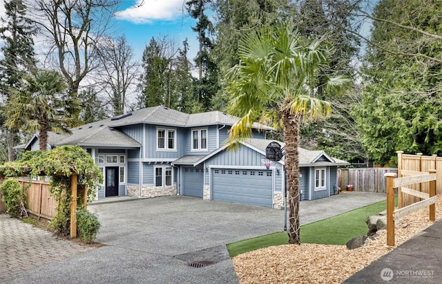 6211 116th Ave NE, Kirkland, WA 98033 - view of front of property featuring stone siding, driveway, a shingled roof, a garage, and board and batten siding