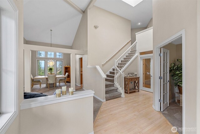 6211 116th Ave NE, Kirkland, WA 98033 - foyer entrance with high vaulted ceiling, stairway, wood finished floors, french doors, and a chandelier