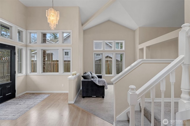 6211 116th Ave NE, Kirkland, WA 98033 - foyer with healthy amount of natural light, wood finished floors, a chandelier, stairway, and high vaulted ceiling