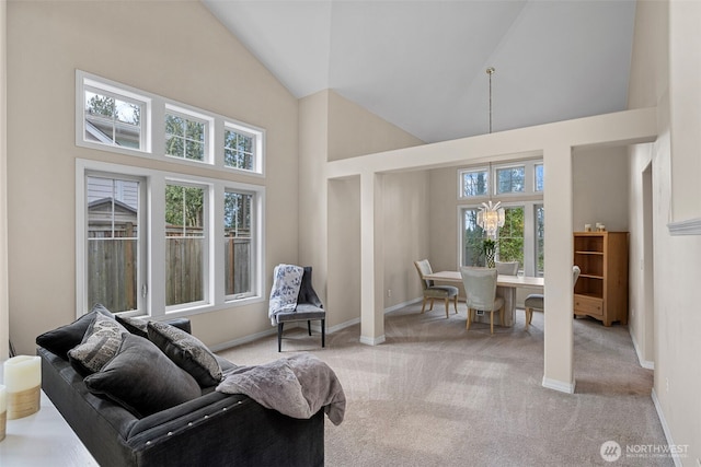 6211 116th Ave NE, Kirkland, WA 98033 - living room featuring high vaulted ceiling, healthy amount of natural light, light carpet, and a chandelier