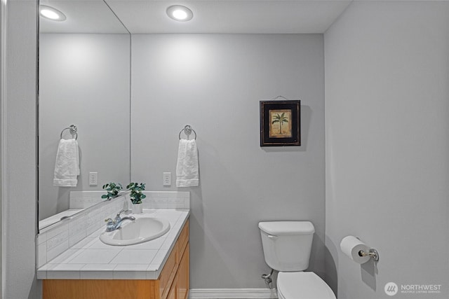 6211 116th Ave NE, Kirkland, WA 98033 - bathroom featuring toilet, vanity, and baseboards