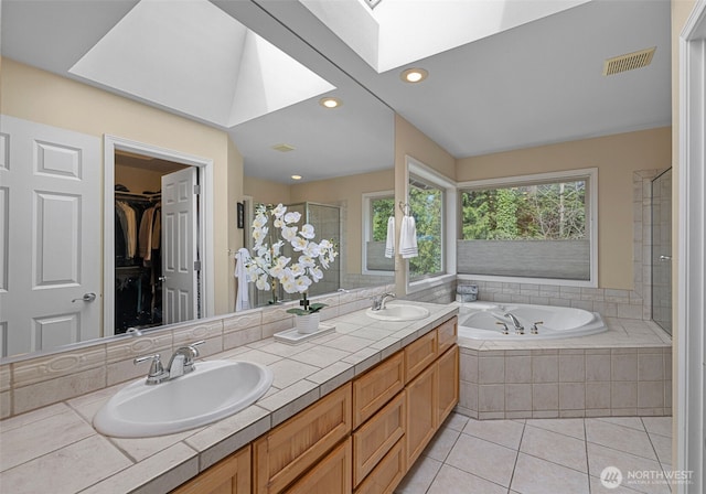 6211 116th Ave NE, Kirkland, WA 98033 - bathroom featuring a skylight, a shower stall, tile patterned flooring, a garden tub, and double vanity