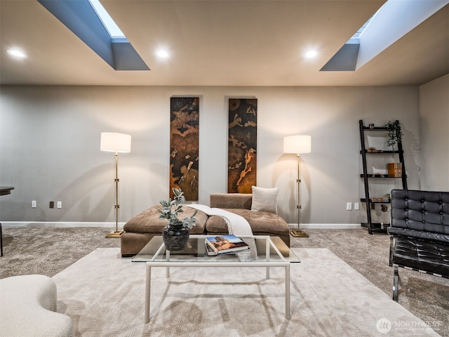 carpeted living area with baseboards, recessed lighting, and a skylight