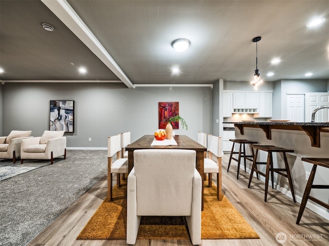 dining room featuring recessed lighting, baseboards, and light wood finished floors