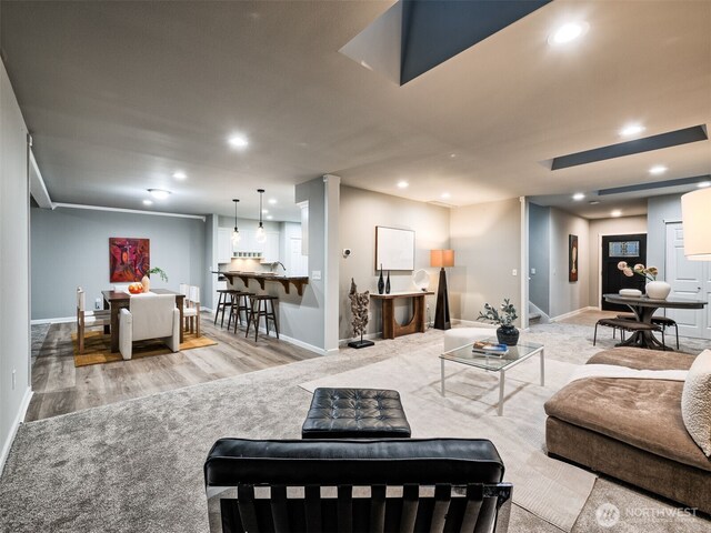 living area featuring recessed lighting, baseboards, and wood finished floors