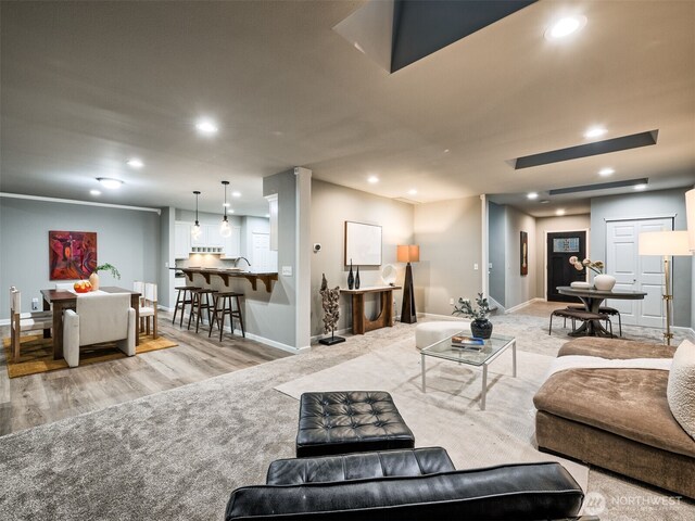 living room with baseboards, recessed lighting, and wood finished floors