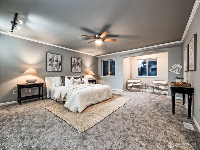 bedroom featuring crown molding, baseboards, carpet flooring, and visible vents
