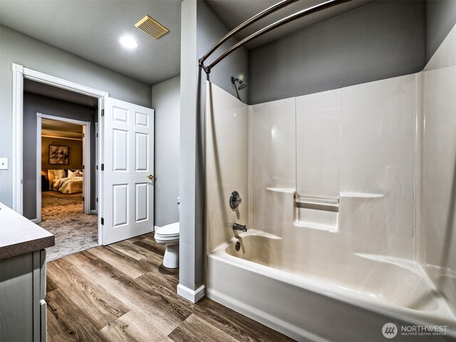 full bath featuring vanity, toilet, shower / bathing tub combination, wood finished floors, and visible vents