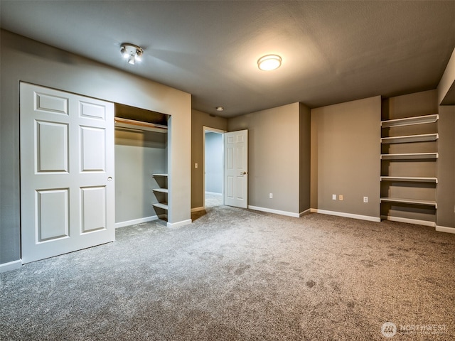 unfurnished bedroom with carpet floors, baseboards, and a closet