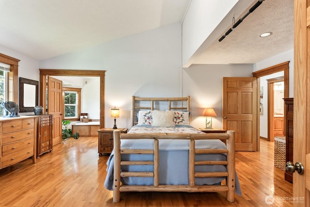 11451 O Ave, Anacortes, WA 98221 - bedroom featuring light wood-style flooring, vaulted ceiling, and multiple windows