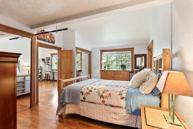 11451 O Ave, Anacortes, WA 98221 - bedroom with lofted ceiling with beams and wood finished floors