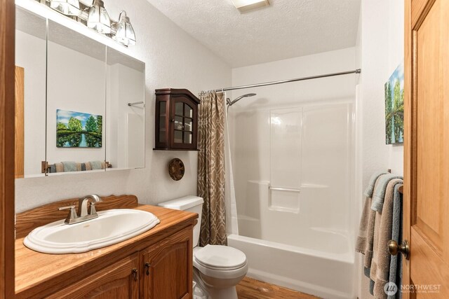 11451 O Ave, Anacortes, WA 98221 - bathroom with a textured ceiling, shower / bath combo, wood finished floors, vanity, and toilet