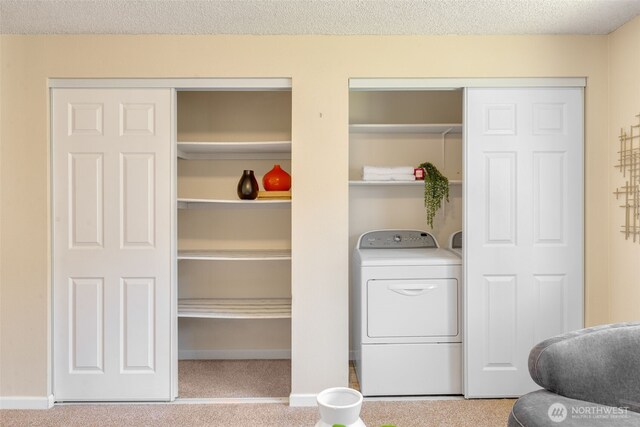 laundry area featuring washer / clothes dryer, carpet, and a textured ceiling