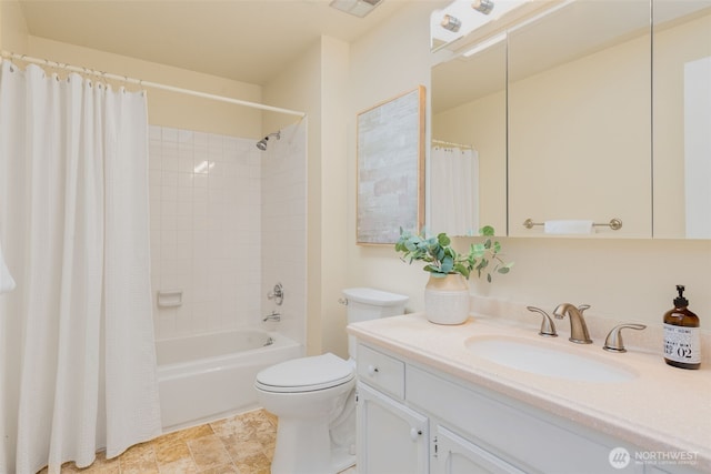 bathroom featuring toilet, vanity, and shower / bath combo with shower curtain