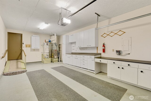 garage with a garage door opener and water heater